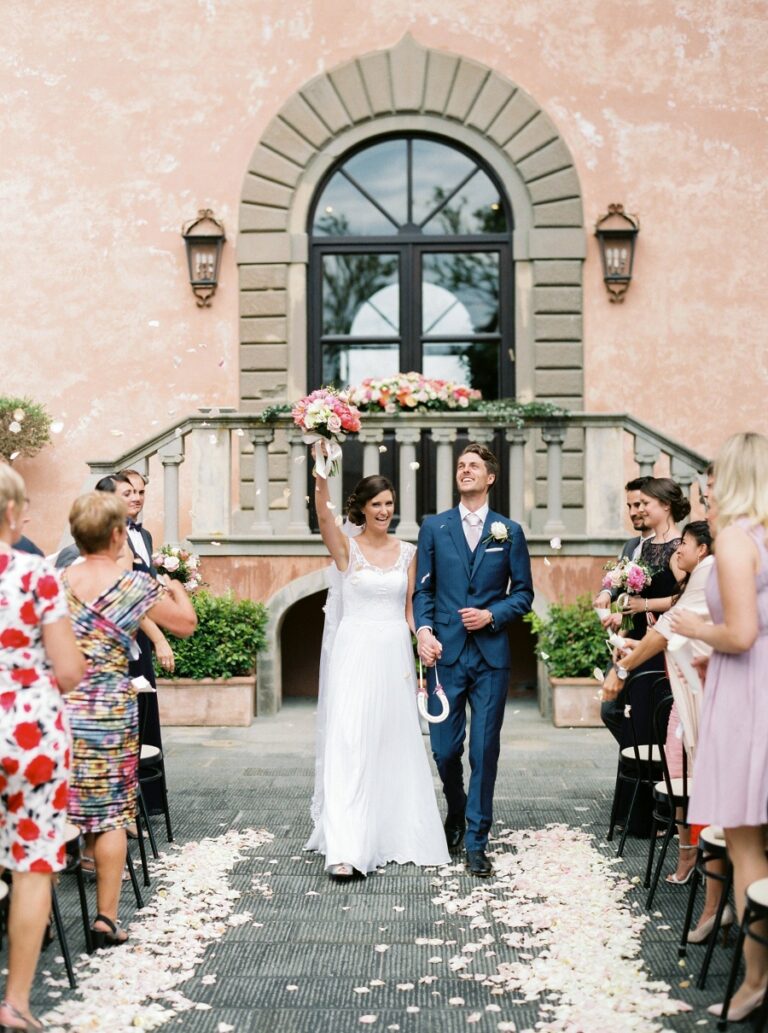 Bridesmaids in black hold blush and pink bouquets before Villa Mangiacane, Franci's Flowers Wedding Design