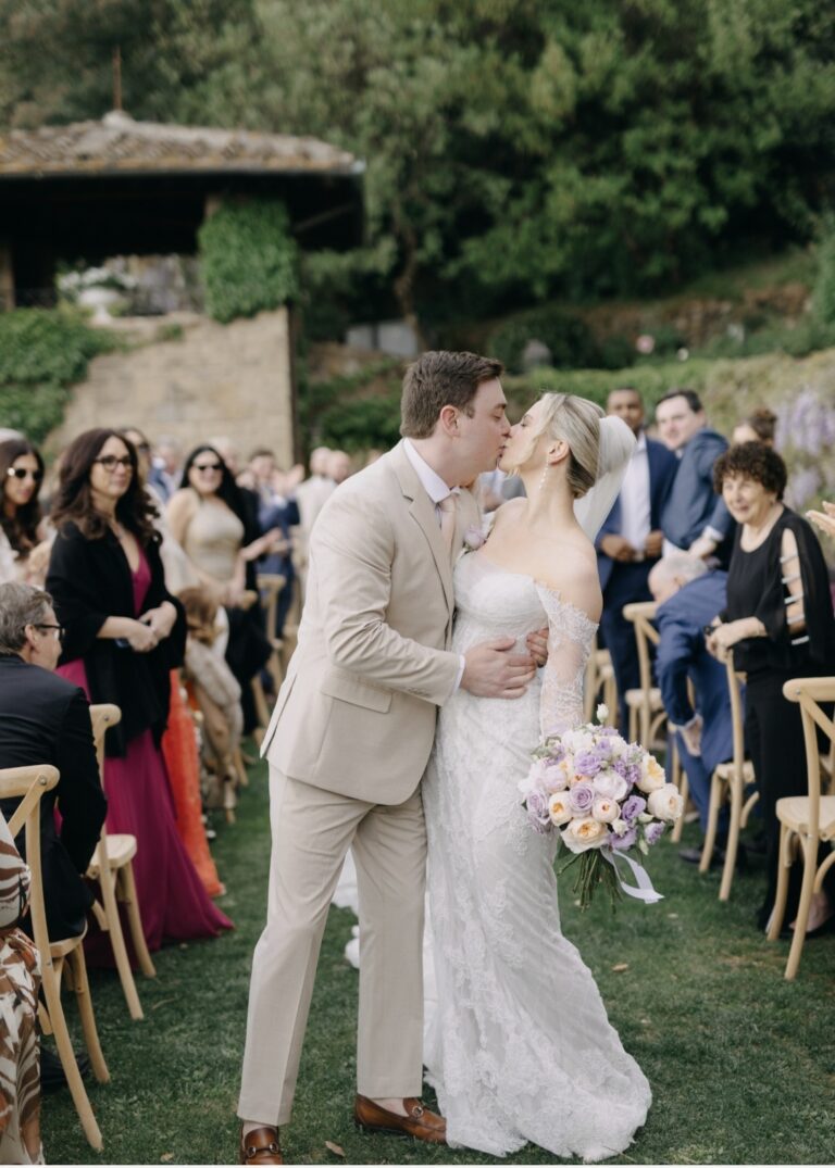 The couple embraces amid confetti, Villa Le Fontanelle, Franci's Flowers Wedding Design