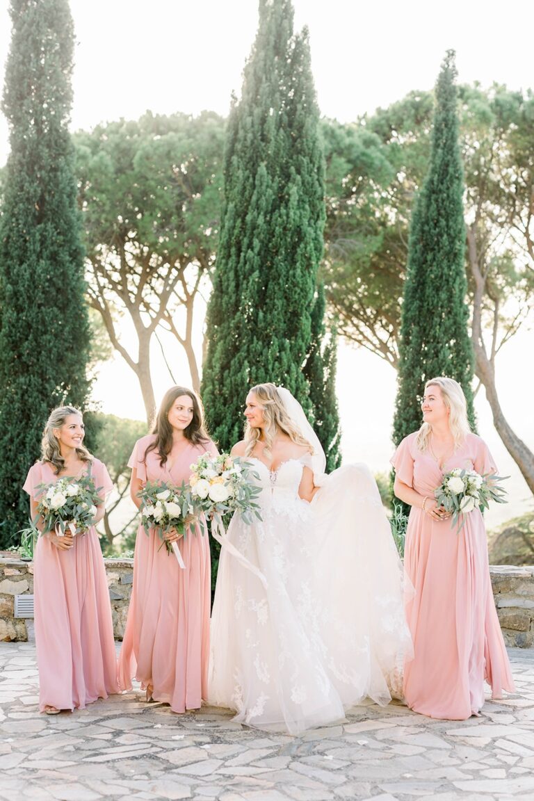 Bridesmaids in blush walk a cypress-lined path, Castello di Segalari, Franci's Flowers Wedding Design