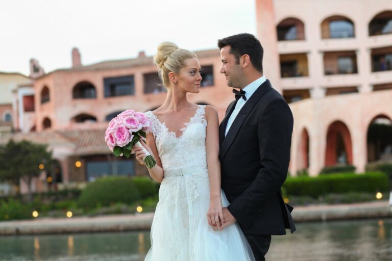 The couple beneath the pink arcades of the Costa Smeralda, Sardinia, Franci's Flowers Wedding Design