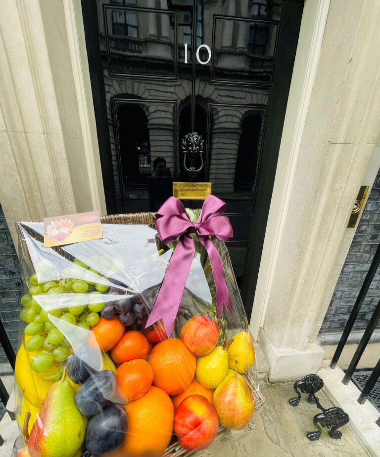 Fruit hamper with ribbon delivered to a London doorstep, Fruity Gift