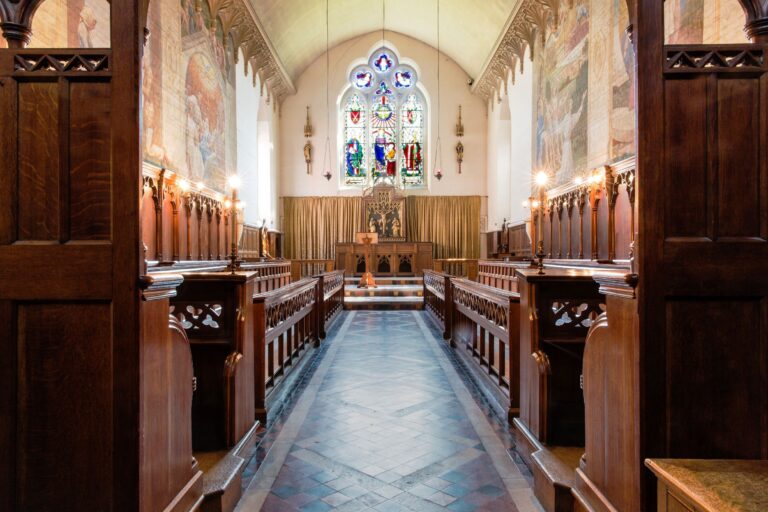 The interior of Bishop Tait's Chapel, its painted walls, tiled floor and stained glass by William Butterfield, Fulham Palace