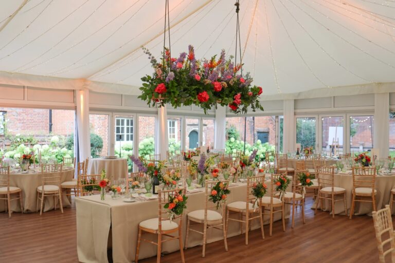 A place setting and centrepiece in the Chaplain's Marquee, laid for a wedding reception, Fulham Palace