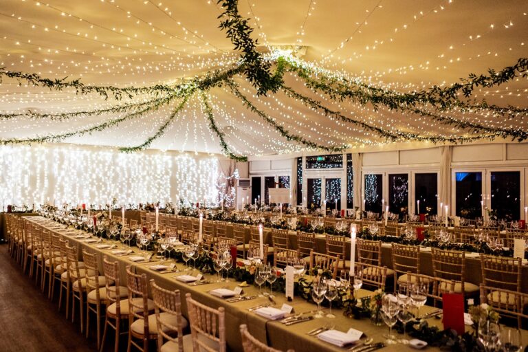 The Chaplain's Marquee at night, festoon lights warm above long winter tables, Fulham Palace