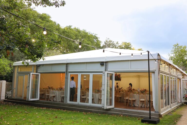 The Chaplain's Marquee by day, a glazed pavilion set out on the garden lawn, Fulham Palace