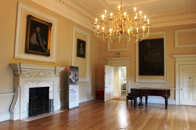 Bishop Sherlock's Room, a grand reception room beneath a decorative plaster ceiling with a chandelier, Fulham Palace