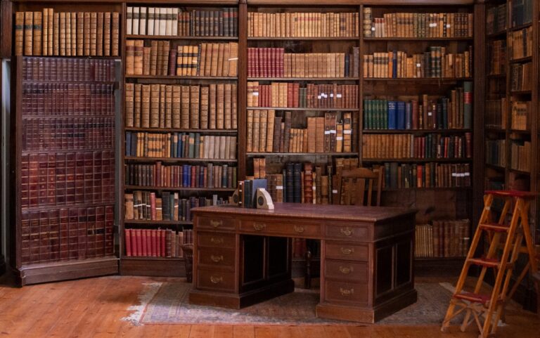 The historic library, book-lined walls, a rolling ladder and a reading desk, Fulham Palace