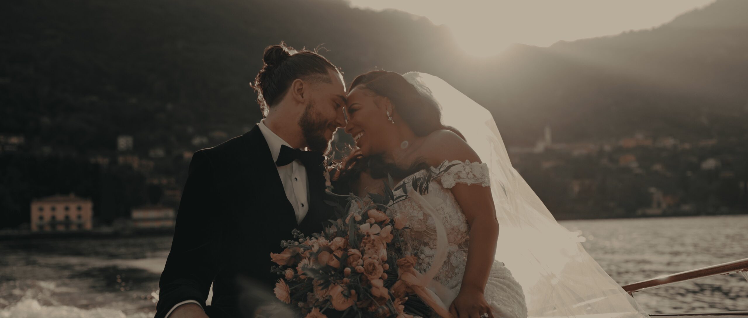 Elaina and Alex on a boat at sunset on Lake Como, from their Villa Aura del Lago wedding film, Gaetano Di Giacomo Media Production