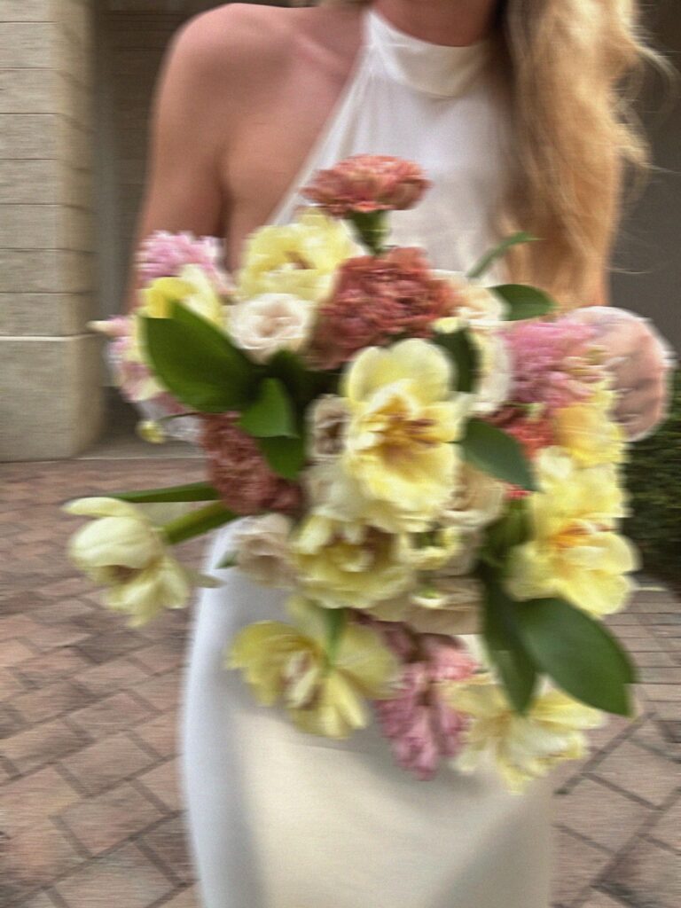 A bride carrying a bouquet of yellow and pink garden flowers, Gaetano Di Giacomo Media Production