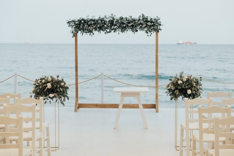 Wooden ceremony frame with greenery on the shoreline platform, Galu Seaside