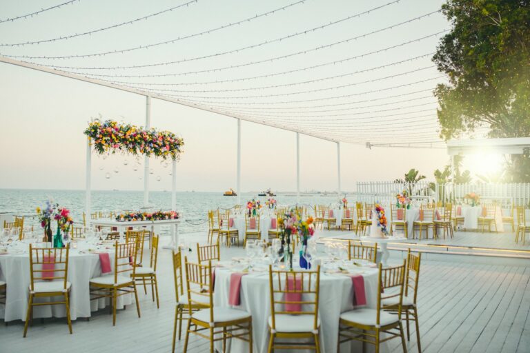 Ceremony arch and dinner tables on the deck in the evening light, Galu Seaside