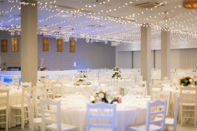The indoor hall with columns, fairy lights and round tables, Galu Seaside