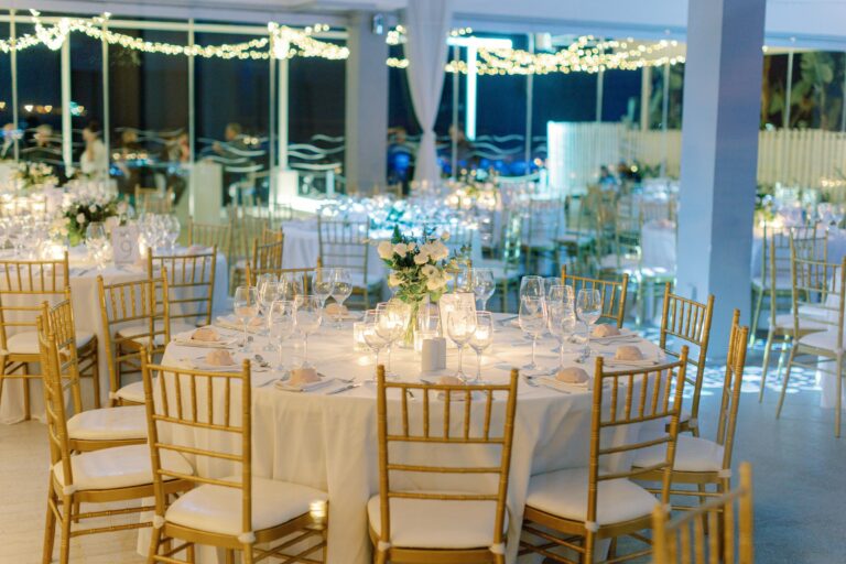 Indoor reception tables with the sea visible through the glass, Galu Seaside
