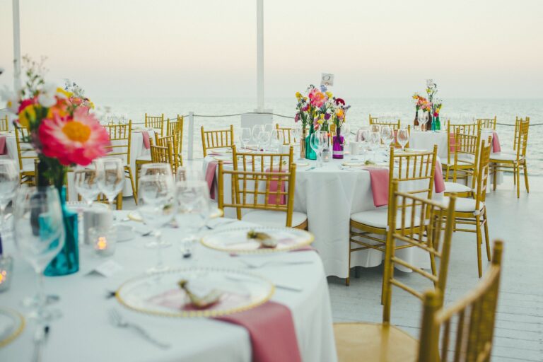 Dinner table with colourful flowers on the deck at dusk, Galu Seaside