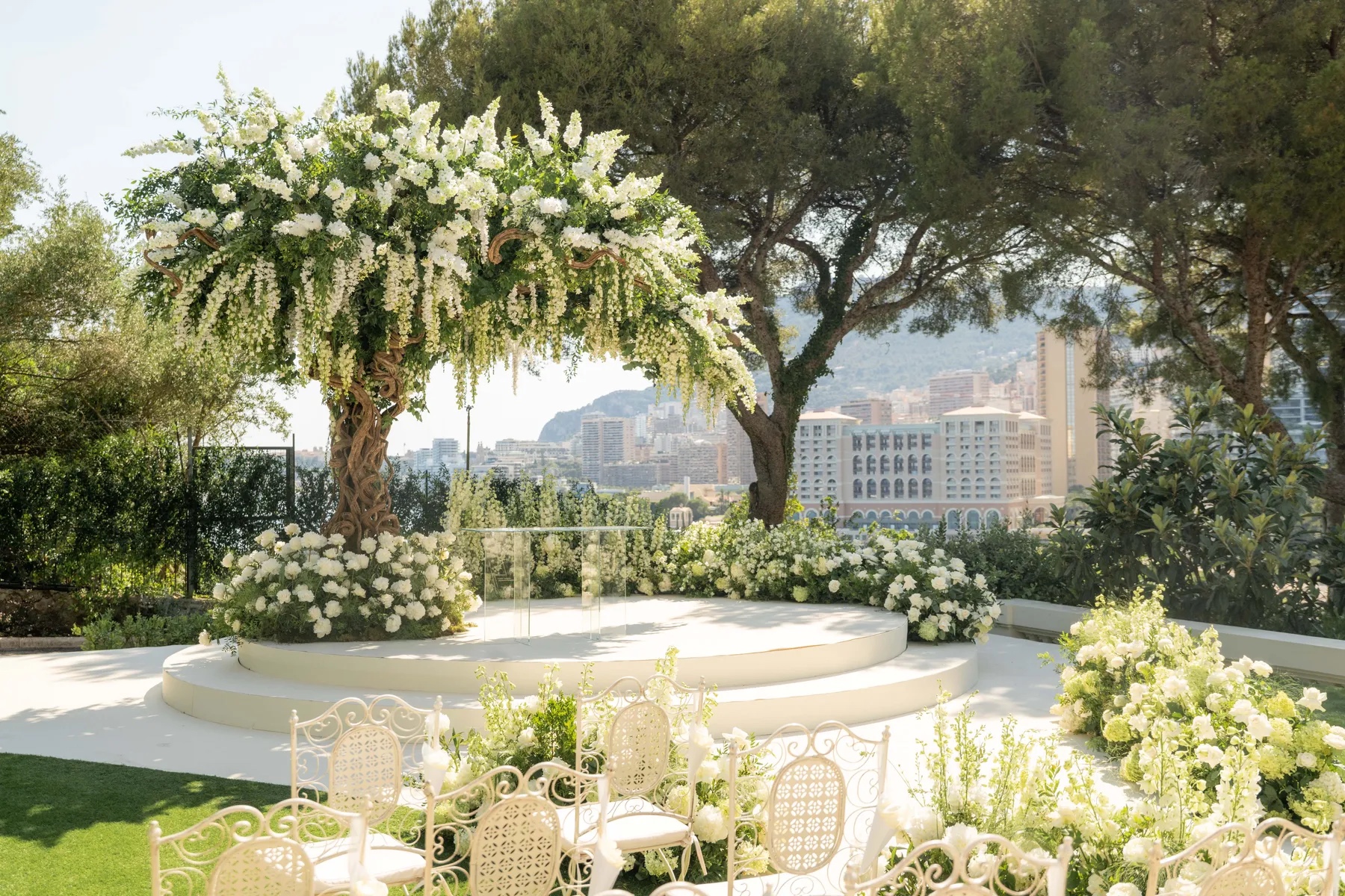 Outdoor ceremony circle framed by a white floral arch, with the coast beyond, Geta Ungurean Agency
