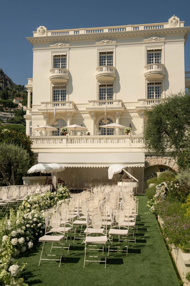 Ceremony chairs laid out on the lawn before a villa, Geta Ungurean Agency