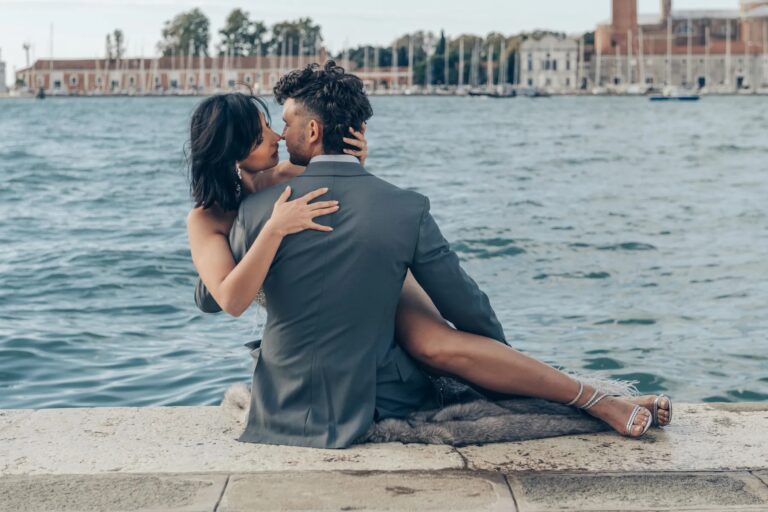 Couple embracing on a stone quay by the water, Geta Ungurean Agency