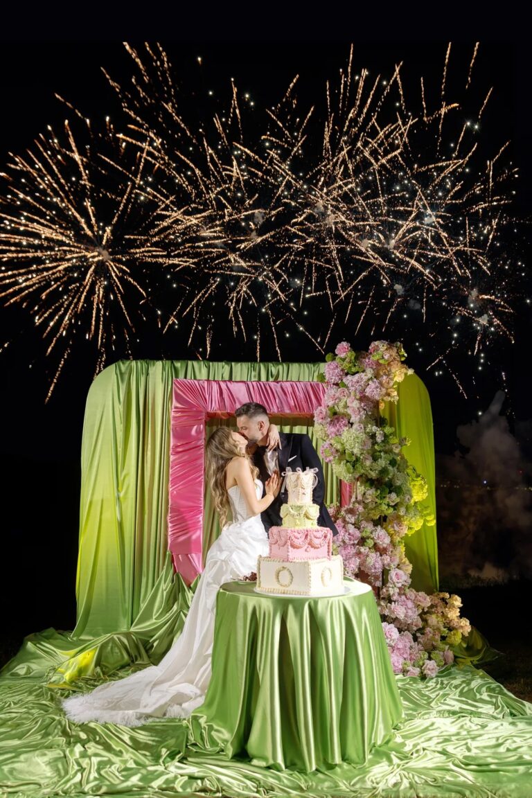Couple at a green and pink cake display under fireworks, Geta Ungurean Agency