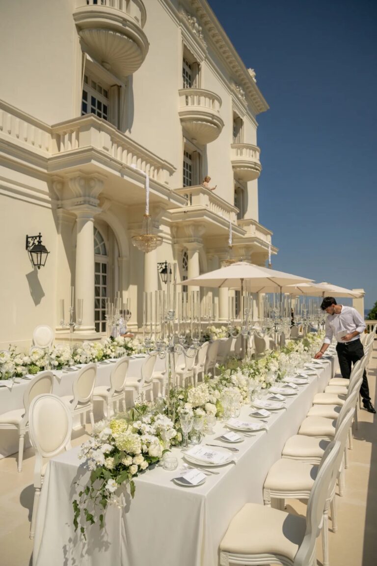 Long white banquet table dressed with flowers on a terrace, Geta Ungurean Agency