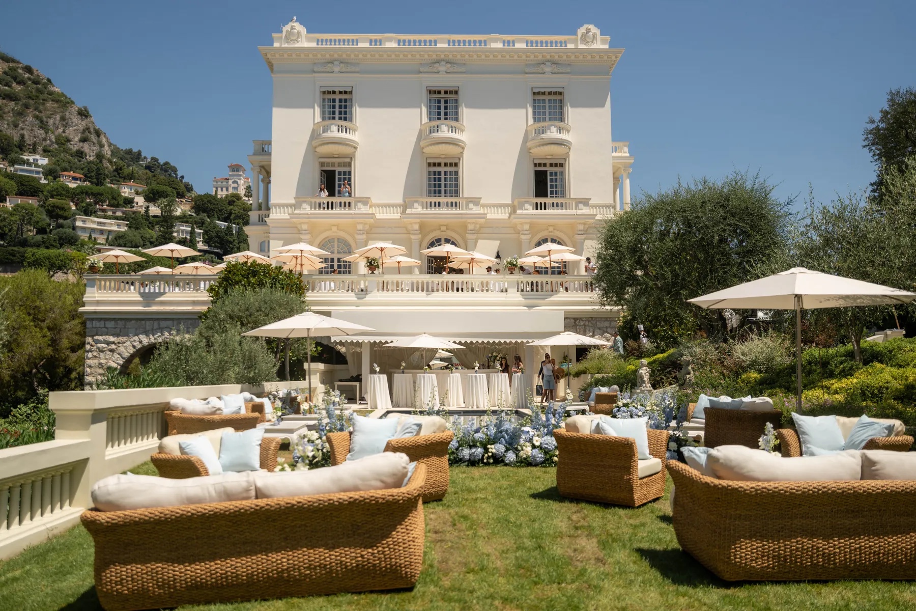 Villa garden set with wicker lounges and umbrellas for the celebration, Geta Ungurean Agency