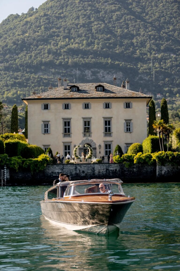 Couple arriving by wooden launch at a lakeside villa, Geta Ungurean Agency