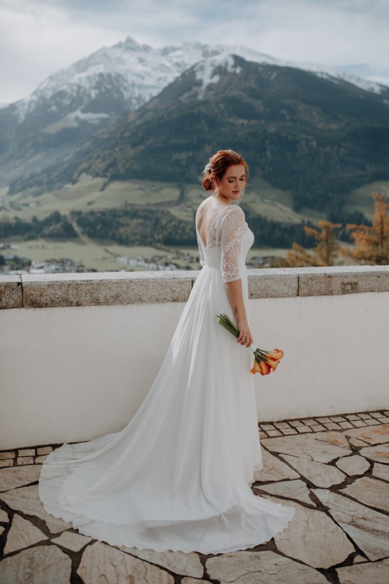 Bride on a terrace with Alpine views at Schloss Mittersill, Getting Married In Austria
