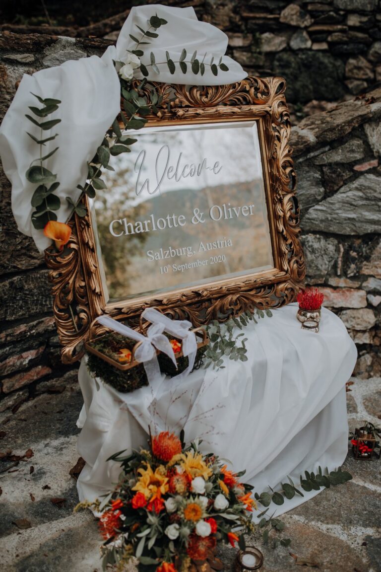 Mirror welcome sign and autumn flowers, Charlotte and Oliver's castle wedding, Getting Married In Austria
