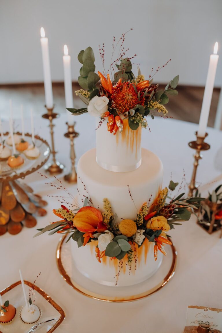 Wedding cake with orange florals and candles, Getting Married In Austria