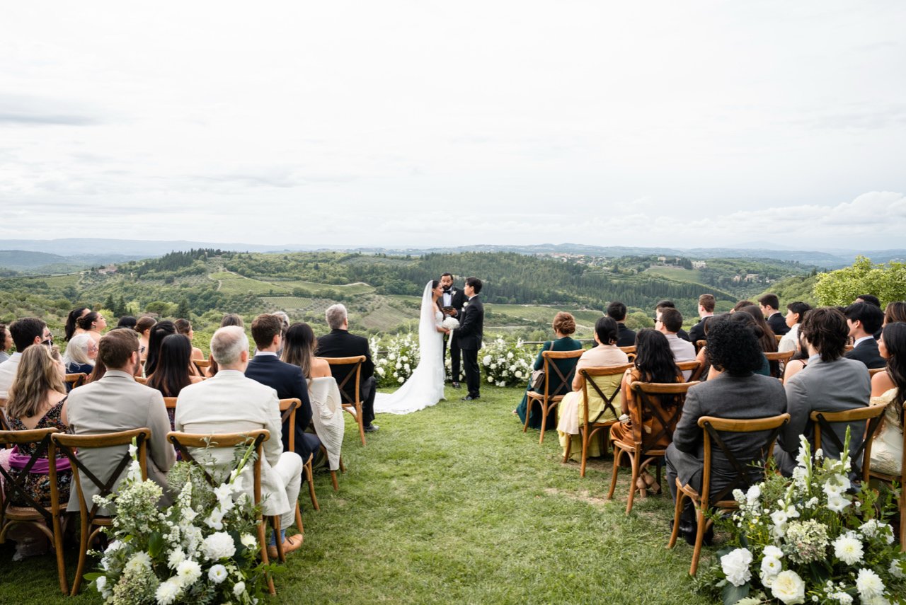 A ceremony on the lawn at Le Filigare in Tuscany, guests seated before the open Chianti hills, Giandomenico Cosentino Photography