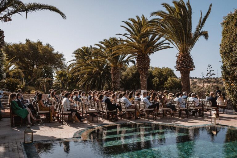 Guests gathered beside the pool and palms for a ceremony at Le Jardin des Douars, Essaouira, Giandomenico Cosentino Photography