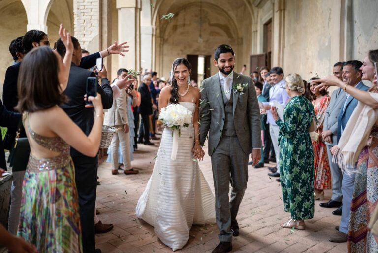 Bride and groom walking out through the cloister at La Certosa di Pontignano, near Siena, Giandomenico Cosentino Photography