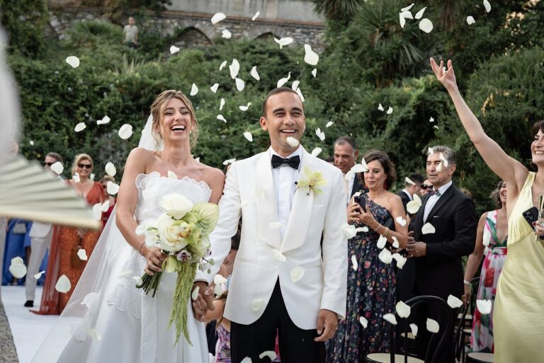 Bride and groom leaving through a shower of petals at Castello Canevaro, Liguria, Giandomenico Cosentino Photography