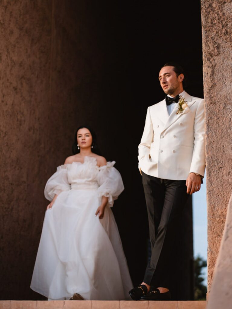 A couple standing in a tall stone opening in warm evening light, Giandomenico Cosentino Photography