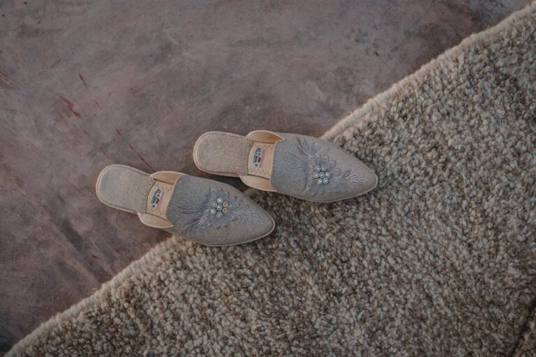 A pair of embroidered slippers on a woven rug at Scarabeo Camp, Marrakech, Giandomenico Cosentino Photography
