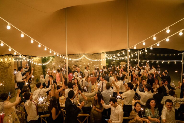 Guests celebrating under a festoon-lit tent at Domaine de Valbonne, Provence, Giandomenico Cosentino Photography