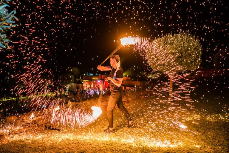 A fire performer sending sparks across the courtyard at Le Palais Paysan, Marrakech, Giandomenico Cosentino Photography