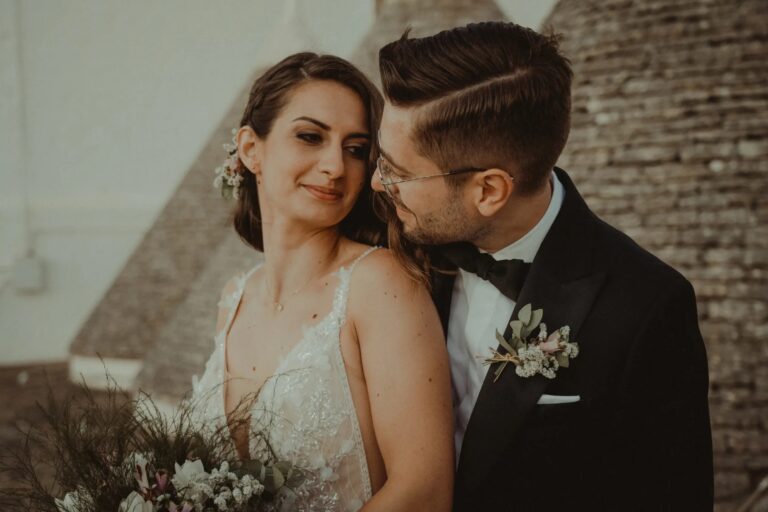 A close portrait of the couple against trullo stone, Valle d'Itria, Puglia, Giuseppe Suma Weddings