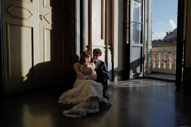 The couple in a palazzo room lit by a tall open window, Siena, Giuseppe Suma Weddings