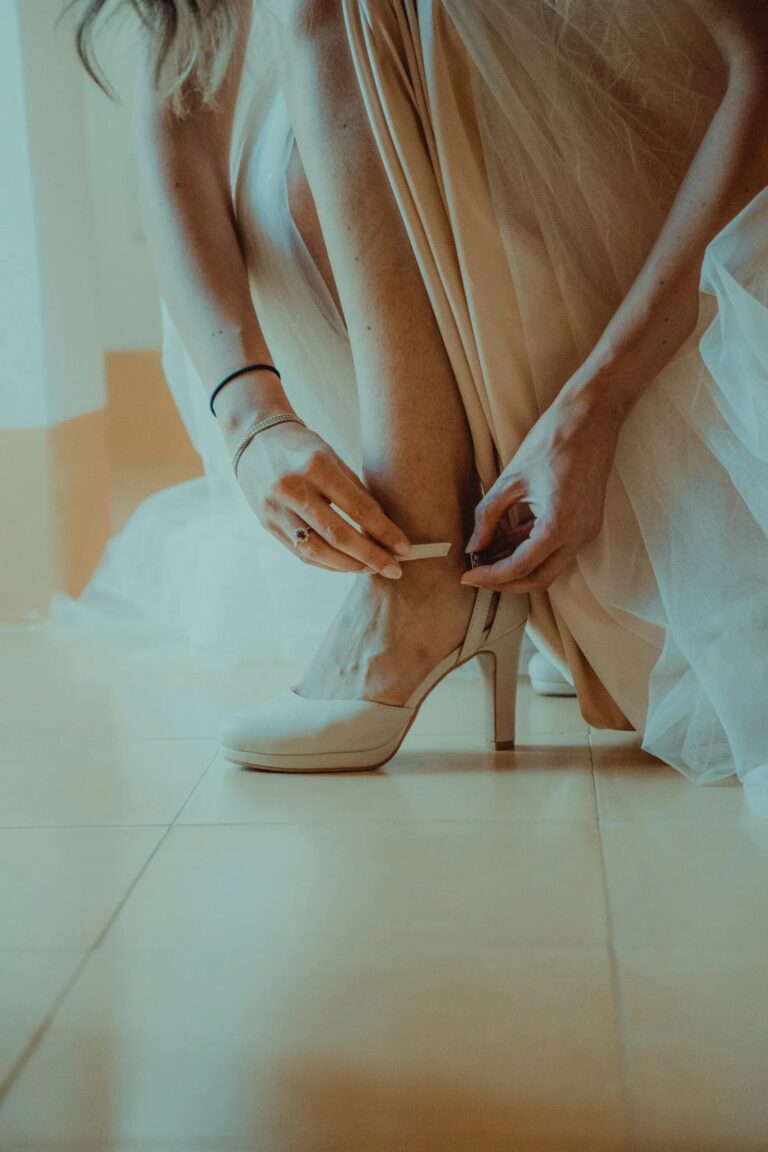 The bride fastening her shoes as she gets ready, Puglia, Giuseppe Suma Weddings