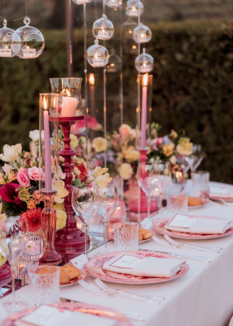 Table detail from a dinner in Florence: pink glass candlesticks, hanging glass votives and pink and coral flowers, Glam Events in Tuscany