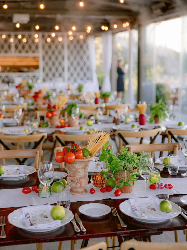 A welcome dinner at Castello del Nero, Tuscany, set like a trattoria: pots of dry pasta, tomatoes, basil and limes along the table, Glam Events in Tuscany