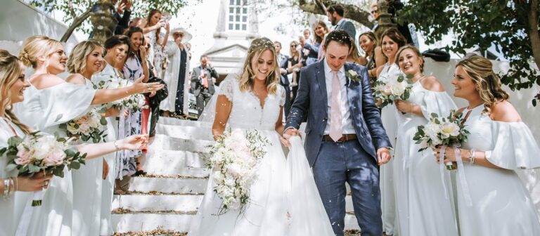 Bridal party descending whitewashed steps after the ceremony, Glamour Algarve Weddings