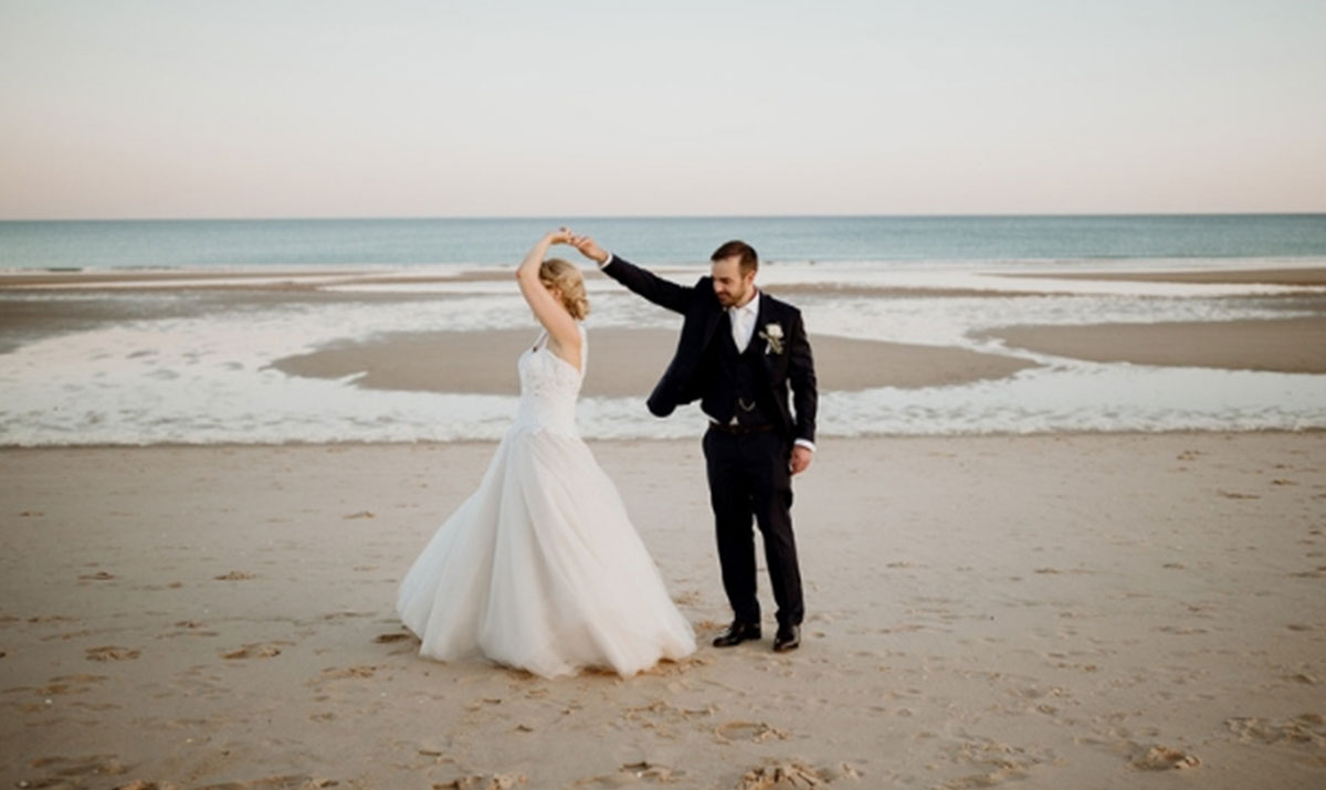 Couple dancing on the shoreline at sunset, Algarve beach, Glamour Algarve Weddings