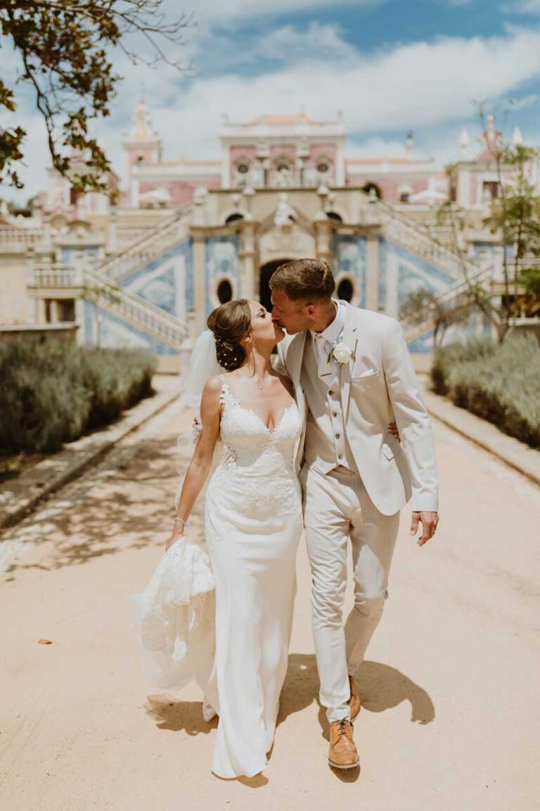 Couple walking in front of the blue-tiled gardens of Estoi Palace, Glamour Algarve Weddings
