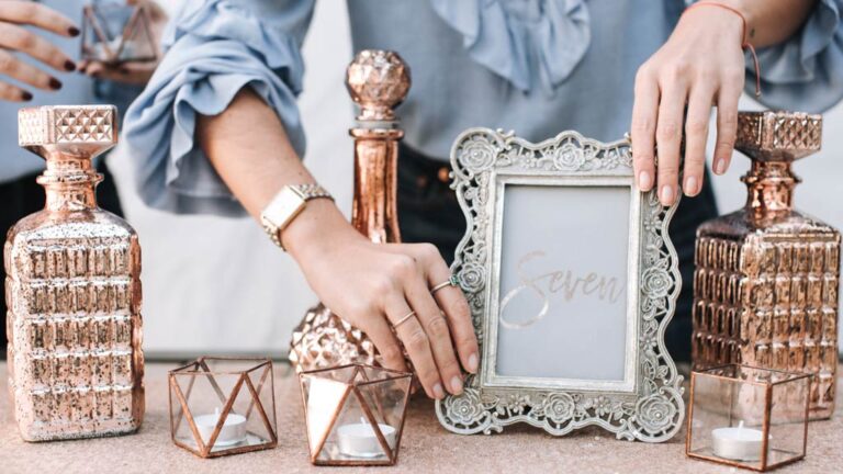 Rose-gold glass decanters, framed table number and candle holders, Glamour Algarve Weddings