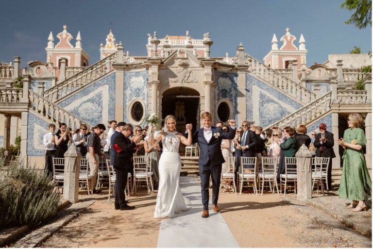Couple and guests on the aisle before the tiled facade of Estoi Palace, Go2Wonderland