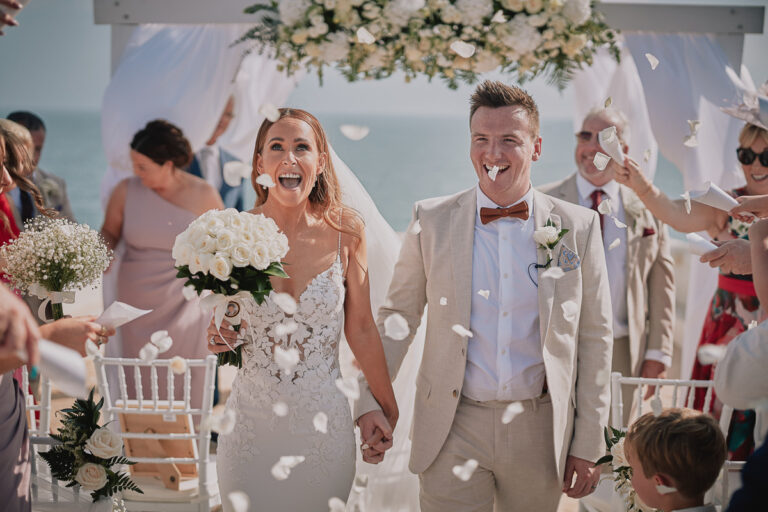 Couple walk through a shower of petals under a floral canopy, Go2Wonderland