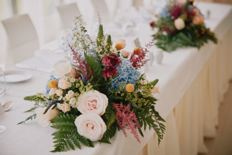Seasonal flowers on a white-draped top table, Go2Wonderland