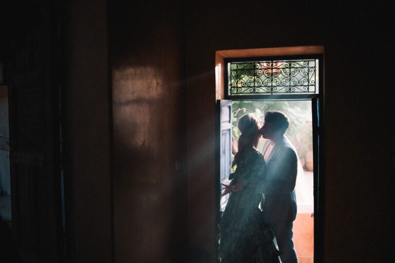 A couple kissing in a shaded doorway, Morocco, Gordon Wedding Films