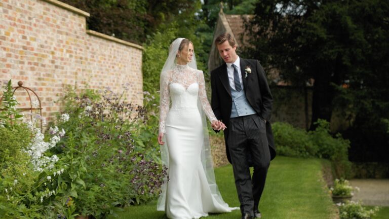 A couple walking hand in hand through a walled garden, Gorgeous Films